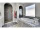 Elegant bathroom featuring a soaking tub, walk-in shower, and modern finishes at 13307 Fawn Lily Dr, Riverview, FL 33579