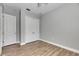 Simple bedroom with wood-look floors and double door closet at 13307 Fawn Lily Dr, Riverview, FL 33579