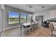 Bright dining area with large windows and a farmhouse table at 13307 Fawn Lily Dr, Riverview, FL 33579
