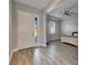 Bright entryway with tile flooring, white door, and view into home office at 13307 Fawn Lily Dr, Riverview, FL 33579