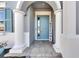 Light blue front door with white columns and a welcome sign at 13307 Fawn Lily Dr, Riverview, FL 33579