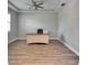 Spacious home office with wood-look floors and large desk at 13307 Fawn Lily Dr, Riverview, FL 33579