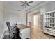 Home office features a desk, chair, shelving, and wood-look tile flooring at 13307 Fawn Lily Dr, Riverview, FL 33579