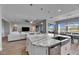 Kitchen boasts a large island with seating, stainless steel appliances, and white cabinets at 13307 Fawn Lily Dr, Riverview, FL 33579