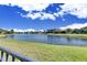 Scenic lake view from backyard, offering tranquil outdoor space at 13307 Fawn Lily Dr, Riverview, FL 33579