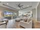 Bright and airy living room with sectional sofa and views of the pool and golf course at 13307 Fawn Lily Dr, Riverview, FL 33579