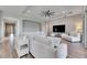 Spacious living room with sectional sofa, wood-look floors, and access to backyard at 13307 Fawn Lily Dr, Riverview, FL 33579