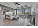 Large main bedroom with wood-look tile floor, ceiling fan, and water view at 13307 Fawn Lily Dr, Riverview, FL 33579