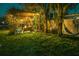 Landscaped backyard with pergola, fire pit and hammock at 13730 Melanie Ave, Hudson, FL 34667