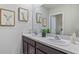 Bathroom with double vanity, speckle countertops, and framed animal prints at 1715 Tahitian Sunrise Dr, Plant City, FL 33565