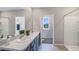 Bright bathroom boasts double sinks, a shower, and an additional room at 1715 Tahitian Sunrise Dr, Plant City, FL 33565