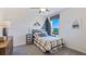 Cozy bedroom with a rustic bed, dresser, and large window at 1715 Tahitian Sunrise Dr, Plant City, FL 33565