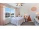Quaint bedroom with a bed, nightstand, and accent wall at 1715 Tahitian Sunrise Dr, Plant City, FL 33565