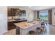 Kitchen features an island and looks out onto a backyard at 1715 Tahitian Sunrise Dr, Plant City, FL 33565