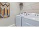 Convenient laundry room with washer, dryer, and shelving at 1715 Tahitian Sunrise Dr, Plant City, FL 33565