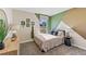 Charming bedroom with a full-size bed and unique wall design at 1716 Tahitian Sunrise Dr, Plant City, FL 33565