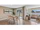 Open dining area with a wooden table and access to the backyard at 1716 Tahitian Sunrise Dr, Plant City, FL 33565