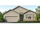 Single-story house with a two-car garage and stone accents at 1716 Tahitian Sunrise Dr, Plant City, FL 33565
