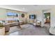 Living area featuring a sectional sofa and access to a bedroom at 1716 Tahitian Sunrise Dr, Plant City, FL 33565
