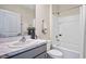 Bathroom with a white bathtub, gray vanity, and marble countertop at 1717 Tahitian Sunrise Dr, Plant City, FL 33565