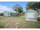 Backyard view of home, shed, and patio at 175 83Rd N Ave, St Petersburg, FL 33702