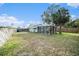 Home's backyard with screened patio and fence at 175 83Rd N Ave, St Petersburg, FL 33702
