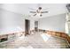 Bedroom with exposed walls and flooring, ceiling fan installed at 175 83Rd N Ave, St Petersburg, FL 33702
