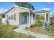 Newly renovated home exterior with a blue door and modern landscaping at 175 83Rd N Ave, St Petersburg, FL 33702