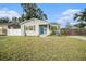 Charming bungalow with a new gray exterior, blue door, and modern fence at 175 83Rd N Ave, St Petersburg, FL 33702