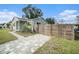 A renovated home with a gray exterior, modern fence, and a paved walkway at 175 83Rd N Ave, St Petersburg, FL 33702