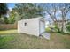 Tan storage shed with roll-up door in backyard at 175 83Rd N Ave, St Petersburg, FL 33702
