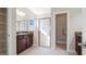 Bathroom featuring double sink vanity, glass shower, and ample natural light at 1838 Tallulah Ter, Wesley Chapel, FL 33543