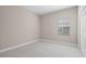 Neutral bedroom with a window and carpeted floors at 1838 Tallulah Ter, Wesley Chapel, FL 33543