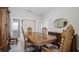 Formal dining room featuring a wooden dining set, mirror, and glass doors at 1838 Tallulah Ter, Wesley Chapel, FL 33543