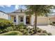 Inviting single-story home featuring manicured landscaping and a covered porch, perfect for relaxing outdoors at 1838 Tallulah Ter, Wesley Chapel, FL 33543