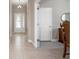 Well-lit hallway featuring tiled flooring and an elegant chandelier, showcasing the home's attention to detail at 1838 Tallulah Ter, Wesley Chapel, FL 33543