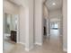 Spacious hallway leads to a bathroom with a tub and vanity, offering convenient access for guests at 1838 Tallulah Ter, Wesley Chapel, FL 33543