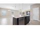Open concept kitchen featuring island with sink and dishwasher overlooking the living area at 1838 Tallulah Ter, Wesley Chapel, FL 33543