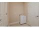 Bright laundry room with tiled floors and utility sink with cabinet storage at 1838 Tallulah Ter, Wesley Chapel, FL 33543