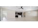 Open floor plan with tile floors flows from the living area into the kitchen with dark wood cabinets at 1838 Tallulah Ter, Wesley Chapel, FL 33543