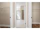 Walk-in closet leading to bathroom featuring shelving and a view of the tiled shower at 1838 Tallulah Ter, Wesley Chapel, FL 33543