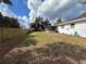 View of backyard, showing the house and wooden fence at 222 Mary Ellen Ave, Seffner, FL 33584