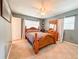 Bedroom with wood bed frame and gray walls at 222 Mary Ellen Ave, Seffner, FL 33584