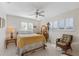 Cozy bedroom with a double bed and wicker chair, offering abundant natural light at 2339 Demaret Dr, Dunedin, FL 34698