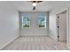 Bright bedroom with two windows, ceiling fan, and gray carpet at 2584 89Th Street E Cir, Palmetto, FL 34221