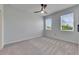 Well-lit bedroom featuring gray carpet and ceiling fan at 2584 89Th Street E Cir, Palmetto, FL 34221