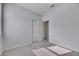 Well-lit bedroom with gray carpet, double doors, and closet at 2584 89Th Street E Cir, Palmetto, FL 34221