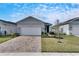 Gray house with white garage door and landscaped yard at 2584 89Th Street E Cir, Palmetto, FL 34221