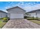 Two-car garage with paver driveway and nicely landscaped front yard at 2584 89Th Street E Cir, Palmetto, FL 34221