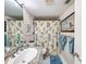 Clean bathroom with shower/tub combo, granite countertop, and bird-themed decor at 2611 Bayshore Blvd # 302, Tampa, FL 33629